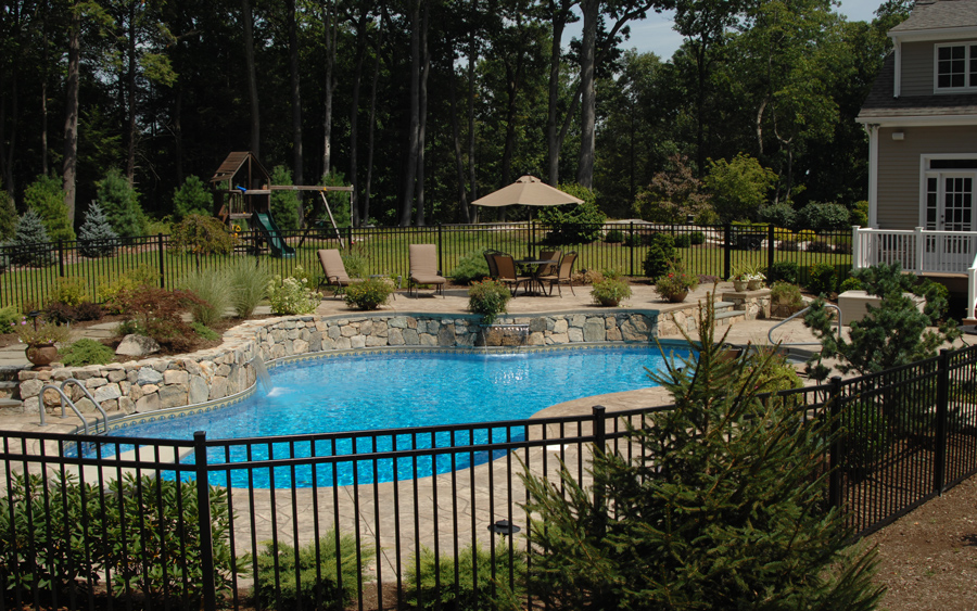 Fence installation with decorative detailing around a pool area